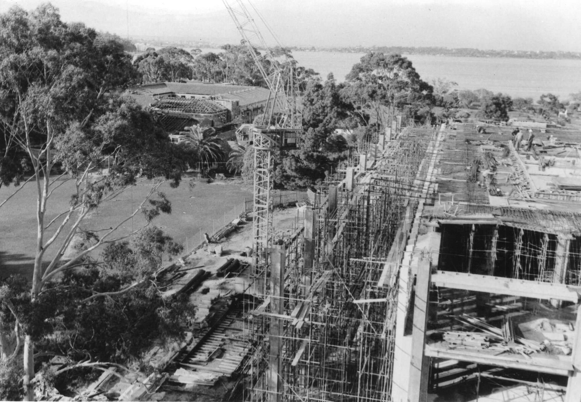 554P - Aerial view of Library Building and Arts Building under construction from Physics Building - Workers on top level of library - 10 June 1963