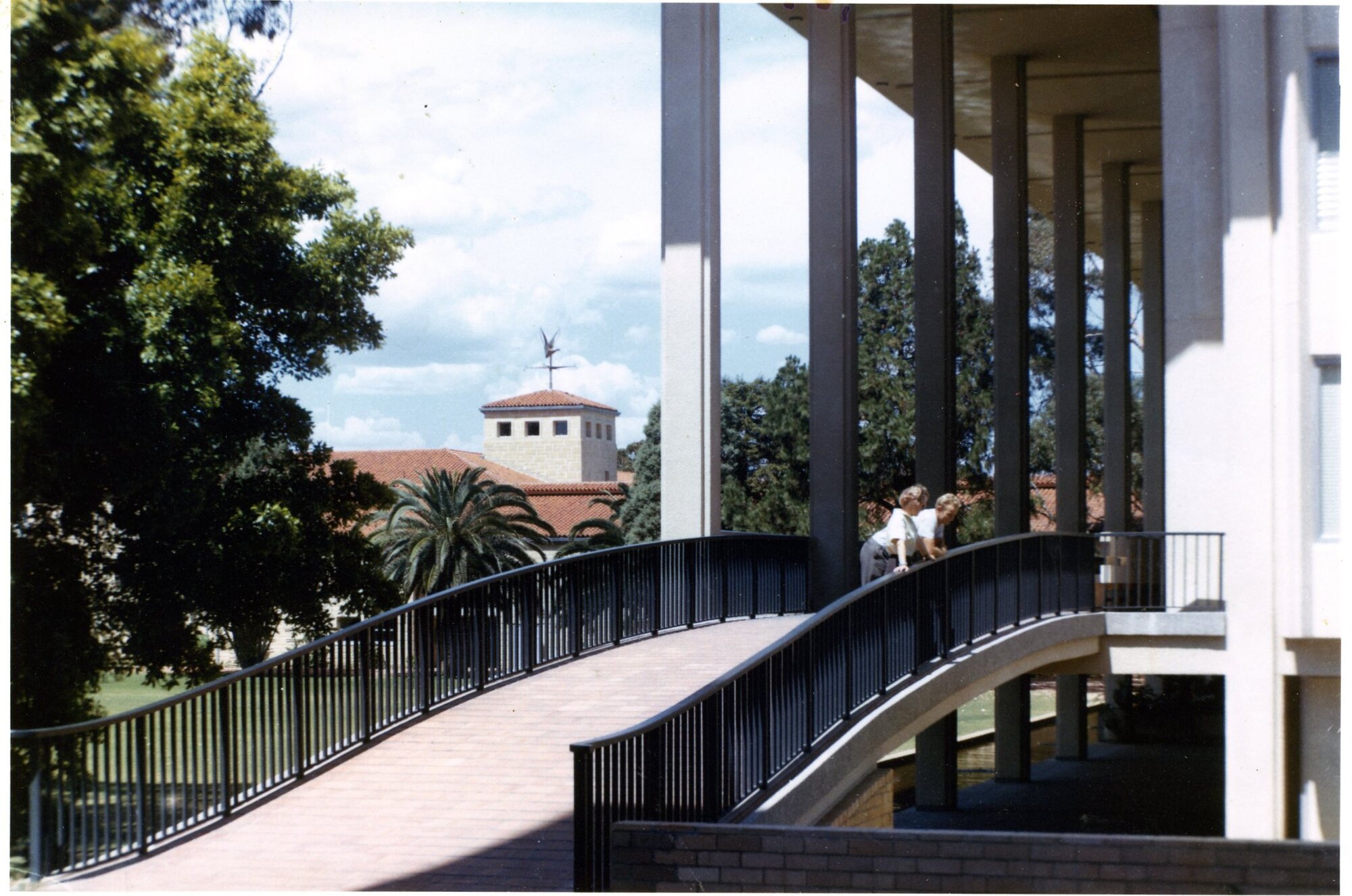 3120P - Students on bridge to Reid Library verandah - Arts building weathervane in background